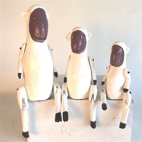 Set of 3 black and white sheep ornaments in varying heights, perfect for adding rustic charm to home decor.
