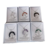 Exquisite display box of 12 Tree of Life pendants featuring 6 designs in vibrant gemstones like Rose Quartz and Amethyst.