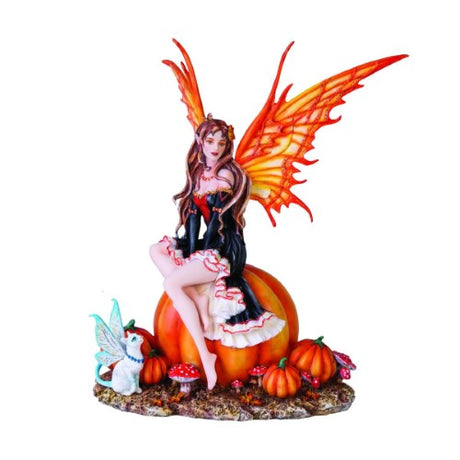 Autumn-themed figurine of a fairy on a pumpkin, adorned in a black gown with orange frills and sparkling wings, with a cat companion.