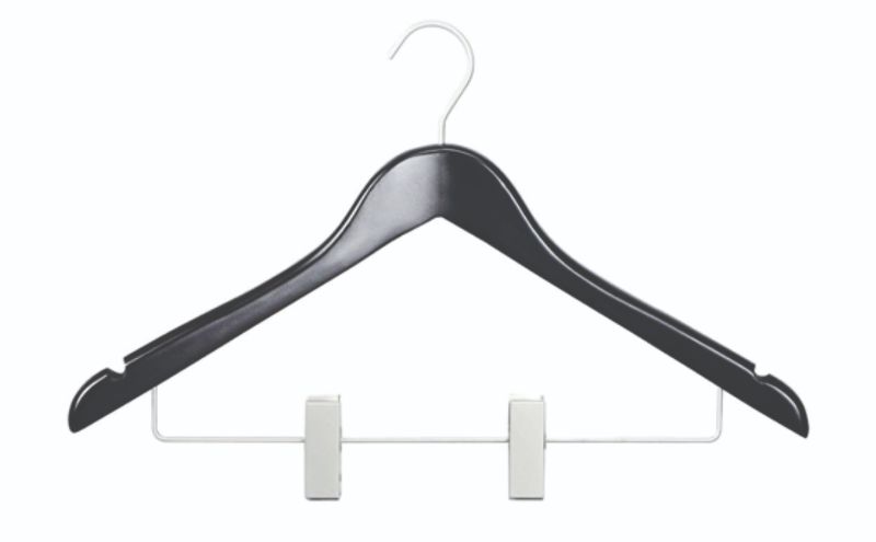 Black wooden coat hanger with robust skirt clips, stylish and eco-friendly for organizing dresses and trousers.