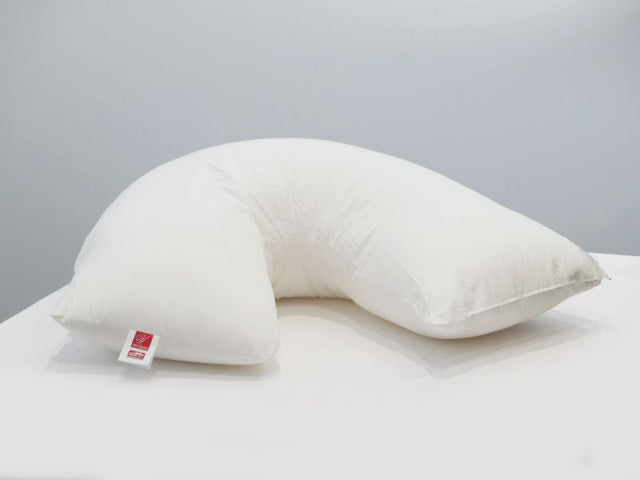 V-shaped Tri Pillow in white, made from eco-friendly microfiber, provides head and neck support for ultimate relaxation.