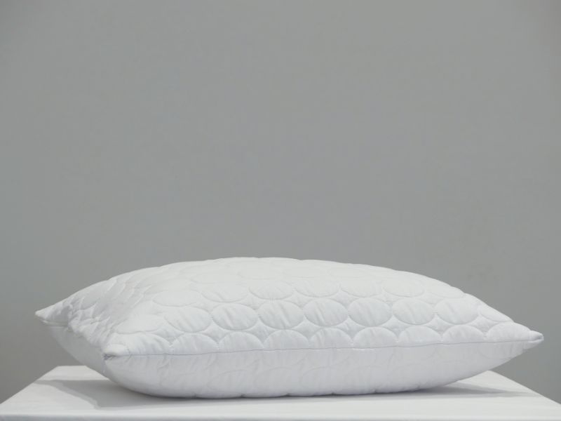 Quilted white pillow protector with edge-to-edge zipper, soft microfibre cover, and 100gsm polyester fill for comfortable sleep.