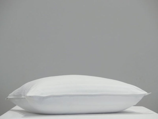 White cotton pillow protector with a 2cm sateen stripe and sturdy zipper for easy use, designed for standard pillows.