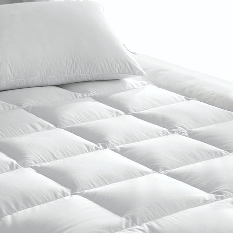 Luxurious double mattress topper made from recycled materials, offering 600gsm microfibre fill and a secure fit for ultimate comfort.