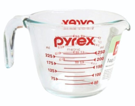 Clear Pyrex measuring jug (250ml) with easy-to-read markings, sturdy handle, and spout for precise cooking and baking.