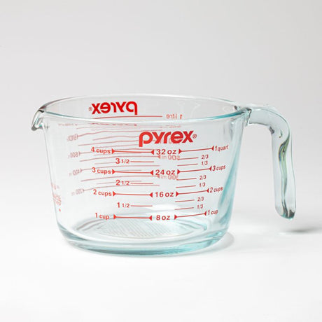 Pyrex 1L measuring jug, made from durable glass, features clear markings and a comfortable handle for precise pouring.