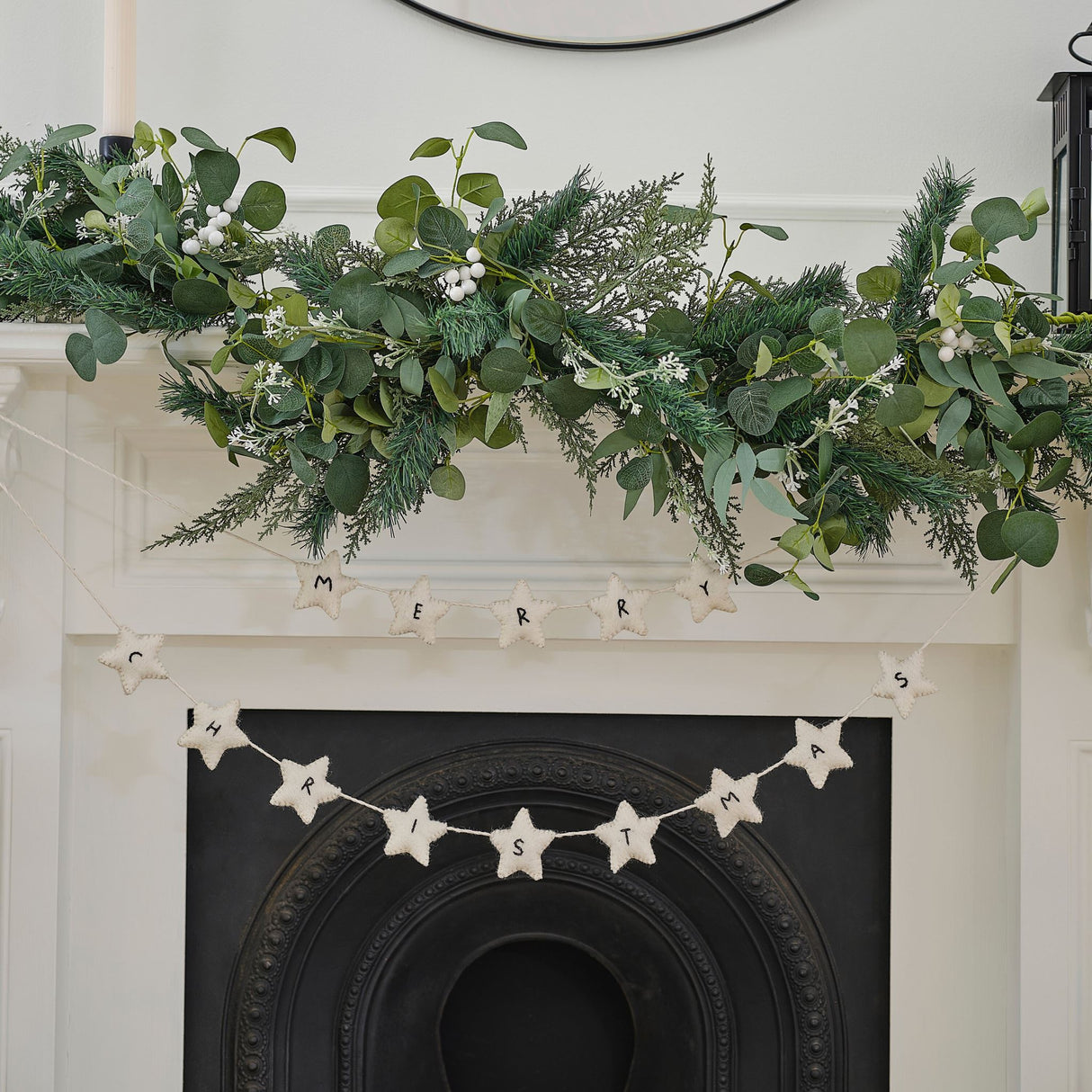 Handmade white felt star bunting for festive holiday decor; eco-friendly, 1.5m long, supports local craftswomen in Nepal.