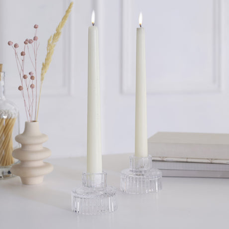 Elegant white glass candle holders with a ribbed texture, perfect for creating a cozy holiday ambiance.