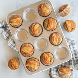 Nordic Ware Naturals® 12-cup muffin pan, made of pure aluminum for even baking, with rust-resistant and durable design.