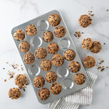 Nordic Ware Naturals Petite Muffin Pan with 24 cups for even baking of miniature treats like muffins and cupcakes.