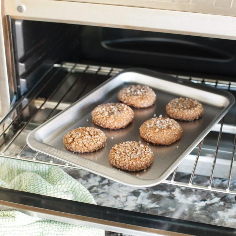 Compact aluminum baking sheet for small-batch cooking, perfect for toaster ovens and individual meals.