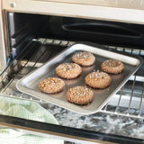 Compact aluminum baking sheet for small-batch cooking, perfect for toaster ovens and individual meals.