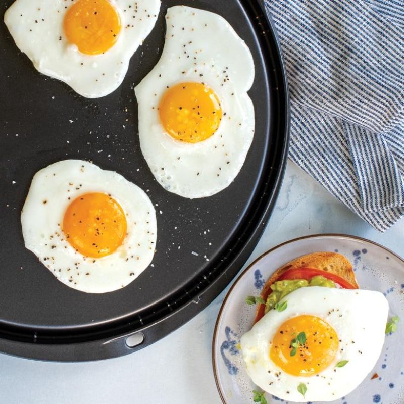 Nordic Ware 12" reversible griddle with nonstick surface for versatile cooking on stovetops, ovens, or grills.