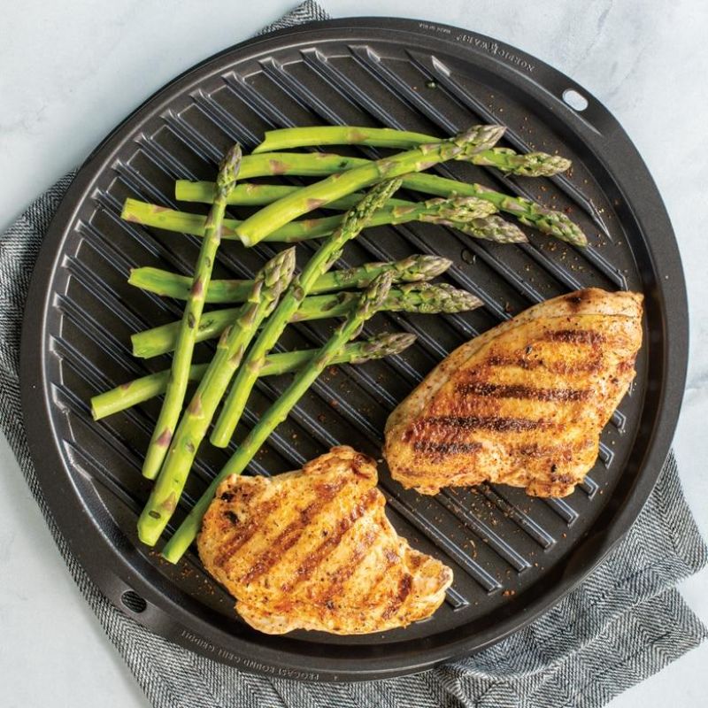 Nordic Ware 12" reversible round griddle, ideal for stovetop, oven, and grill cooking with nonstick, heavy cast aluminum design.