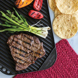 Nordic Ware Two-Burner Reversible Griddle with smooth and ribbed surfaces for versatile indoor cooking and grilling.