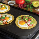 Nordic Ware Two-Burner Reversible Griddle for versatile cooking; smooth and ribbed surfaces for perfect indoor grilling.