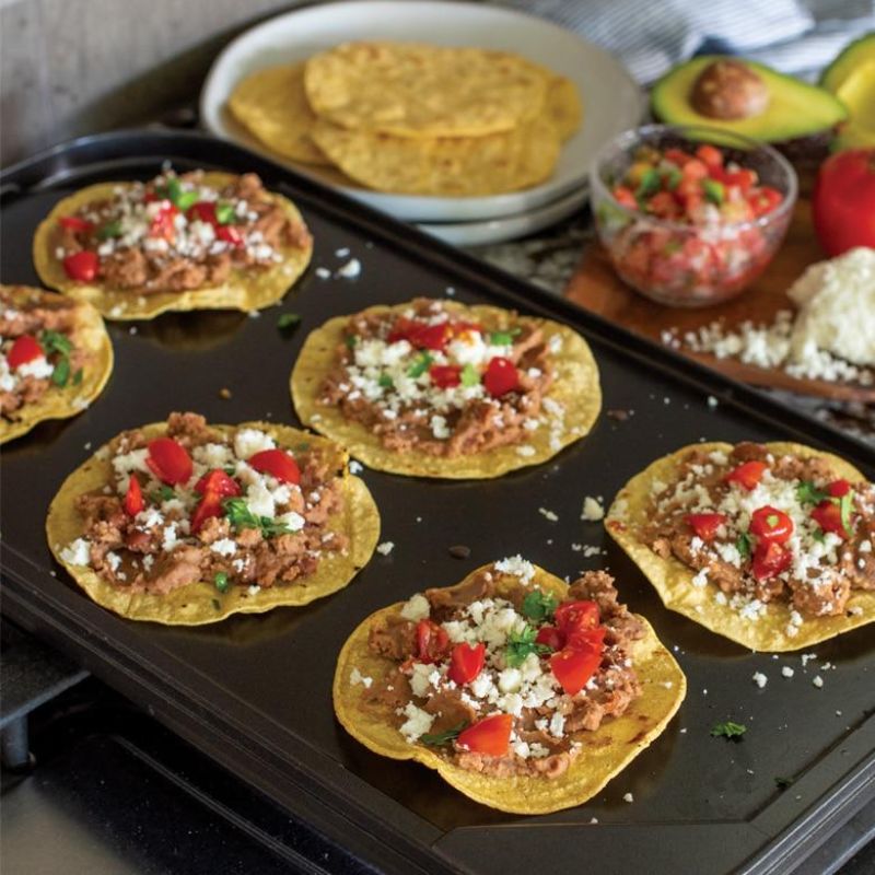 Nordic Ware Two-Burner Griddle with reversible smooth and ribbed surfaces for versatile indoor cooking.