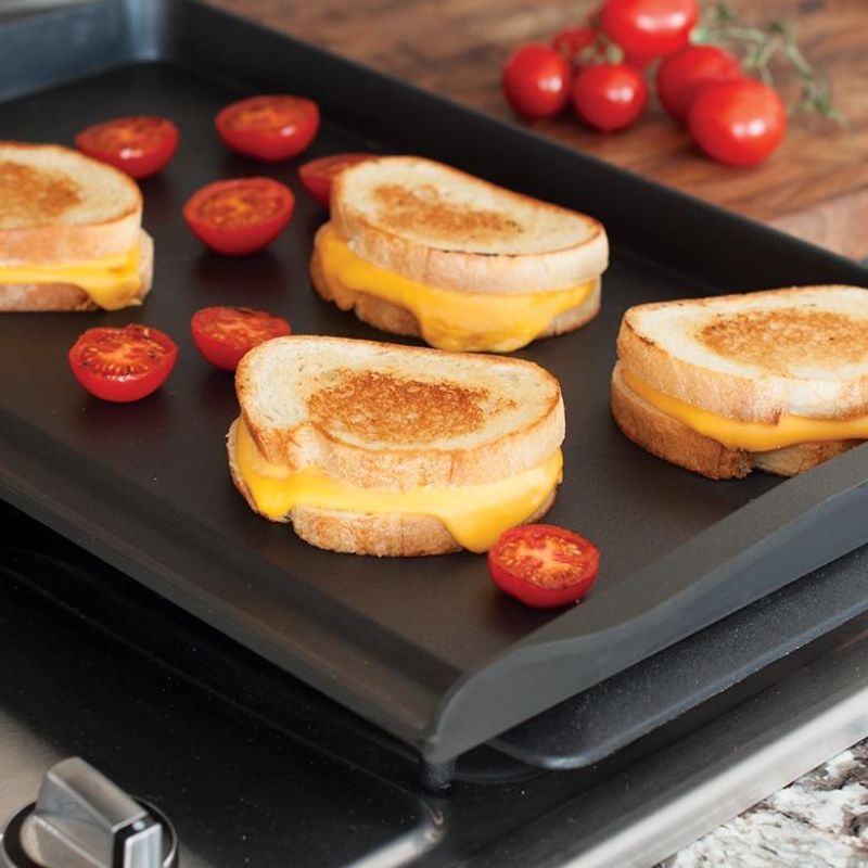 Nordic Ware Double Backsplash Griddle with nonstick coating, 11.4x18.6 inches, designed for mess-free cooking on any stovetop.