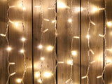 Elegant curtain lights with 600 warm white bulbs, 2M x 6M, perfect for creating enchanting indoor and outdoor ambiances.