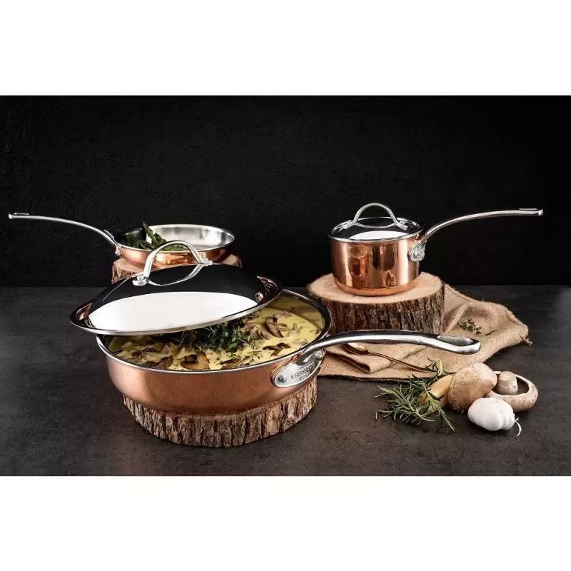 Copper 14cm saucepan with stainless steel interior, designed for even heat distribution and elegant cooking.