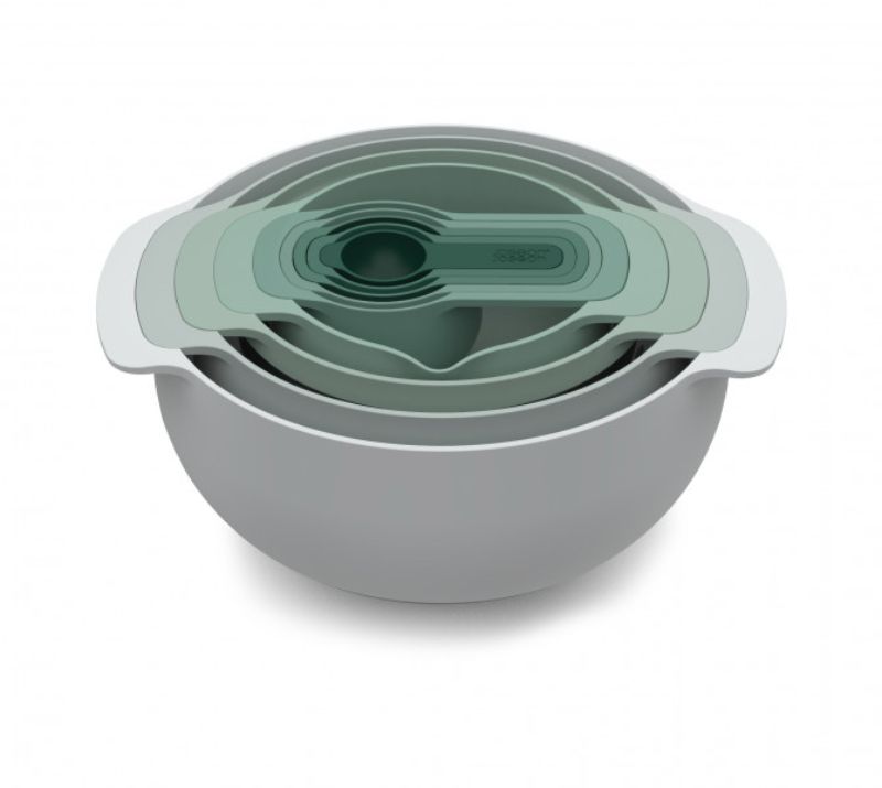 Joseph Joseph Nest 9-piece bowl set in sage green, featuring space-saving design, mixing bowls, colander, sieve, and measuring cups.