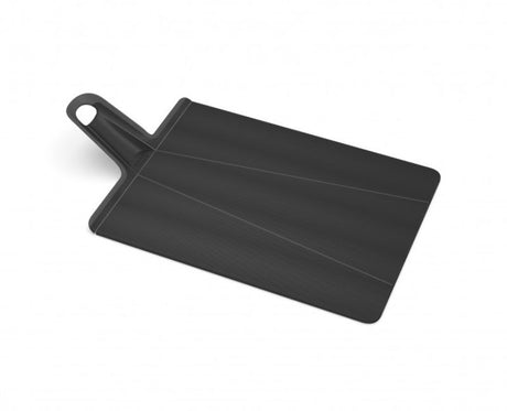 Large black folding chopping board with a textured surface and non-slip feet for easy ingredient transfer and cleanup.