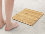 Digital bathroom scale with bamboo surface, LED display, supports 180 kg, stylish design, and anti-slip feet for safety.