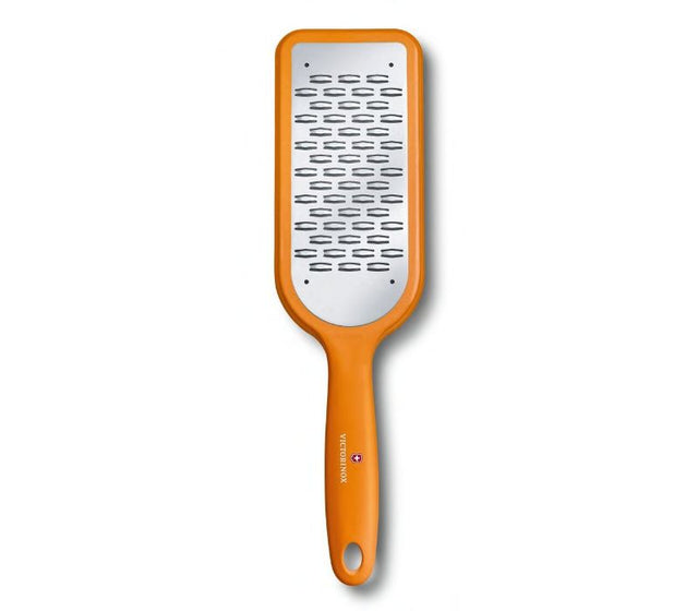 Victorinox Ribbon Edge Grater in vibrant orange features a sharp bidirectional blade for effortless grating of various foods.