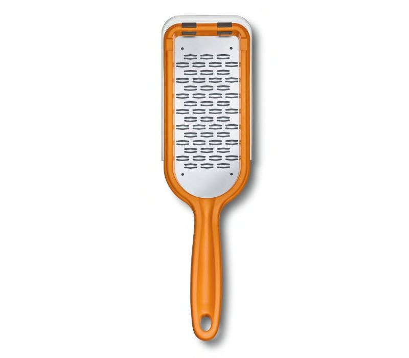 Victorinox orange ribbon edge grater with sharp bidirectional blade, perfect for creating textured shavings of chocolate and cheese.