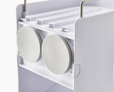 Joseph Joseph Capsule Compact 2-Tier Shower Shelf with stainless-steel rail, suction cups, and angled pockets for efficient storage.