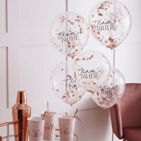 Blush pink balloons filled with rose gold confetti for a chic Team Bride hen party celebration.