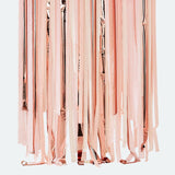 Pink and rose gold streamer backdrop featuring vibrant crepe paper and balloons, perfect for festive celebrations and photo booths.