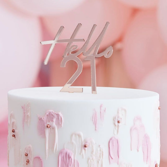 Rose gold acrylic cake topper reading "Hello 21," perfect for celebrating a milestone 21st birthday in style.