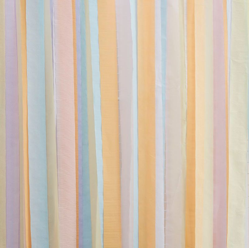 Pastel streamer backdrop featuring pale pink, yellow, lilac, peach, and blue, ideal for vibrant party photos.