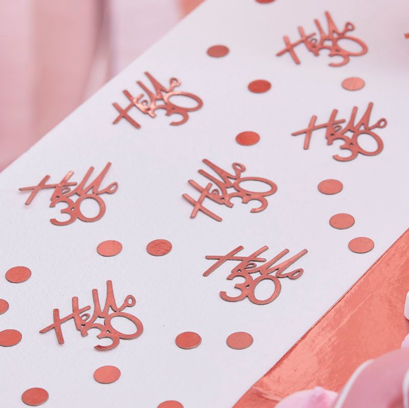 Rose gold birthday confetti featuring 'Hello 30' pieces and circles for a glamorous 30th celebration.