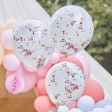 Double-layered white balloons filled with vibrant rainbow confetti, ideal for festive occasions and stylish decor.