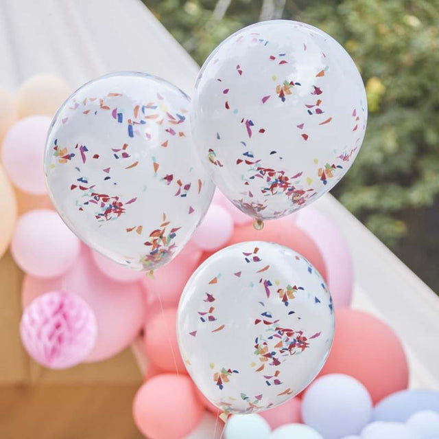 Double-layered white balloons filled with vibrant rainbow confetti, ideal for festive occasions and stylish decor.