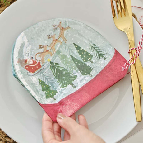 Snowglobe-shaped Christmas paper napkins featuring a whimsical design, perfect for festive celebrations and eco-friendly.