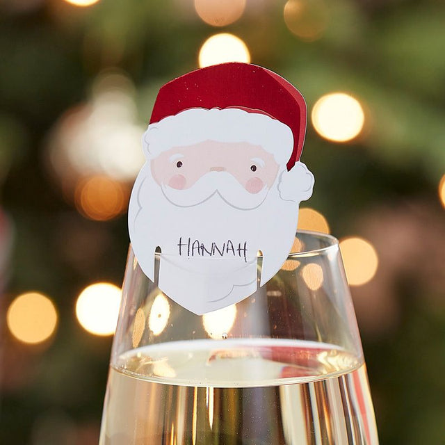 Whimsical Santa glass decorations for holiday drink charm, perfect for festive table settings and guest name tagging.