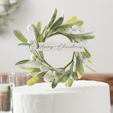 Elegant Christmas cake topper featuring lifelike mistletoe, 'Merry Christmas' script, and durable stainless steel design.