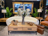 Stylish oak coffee table with 4 drawers, featuring a natural finish and black metal accents for modern decor.