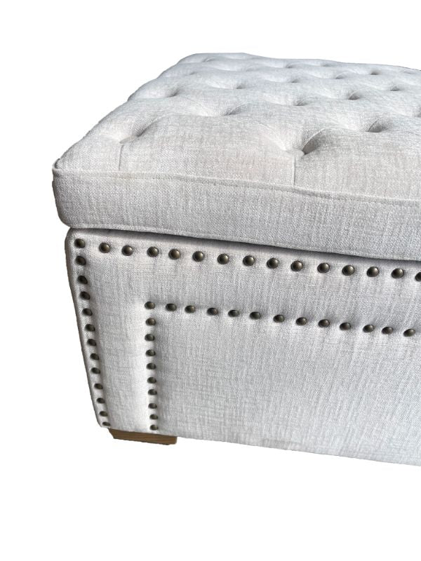 Luxurious cream oversized ottoman with linen upholstery, sturdy timber frame, and metal handles, ideal for storage and decor.