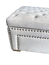 Luxurious cream oversized ottoman with linen upholstery, sturdy timber frame, and metal handles, ideal for storage and decor.