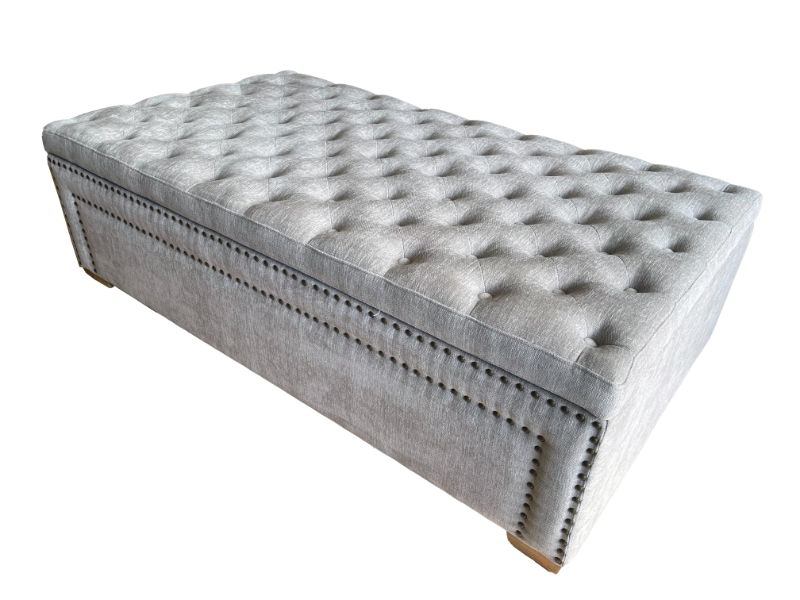 Oversized grey linen ottoman blanket box with storage, metal handles, and a stylish design for modern bedroom décor.