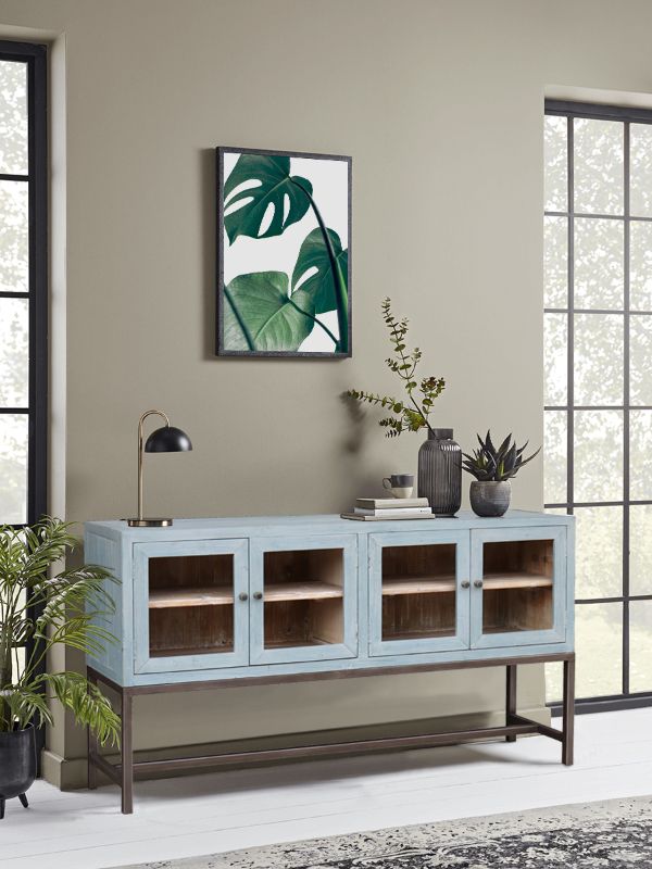 French Country sea-salt kitchen console in old pine, featuring four doors and sturdy metal handles for stylish storage.