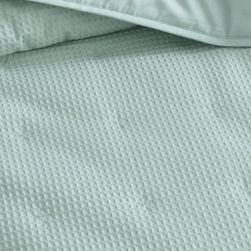 Elegant textured waffle weave coverlet for single or double beds, offering warmth and style in a luxurious cotton-polyester blend.