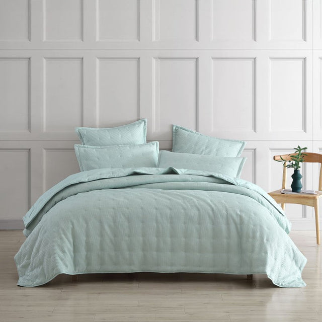 Elegant textured waffle weave coverlet for single and double beds, crafted from a soft polyester-cotton blend.