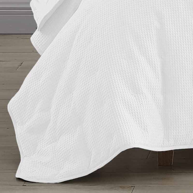 Elegant white quilted coverlet with textured waffle weave, perfect for single or double beds, measuring 180cm x 220cm.