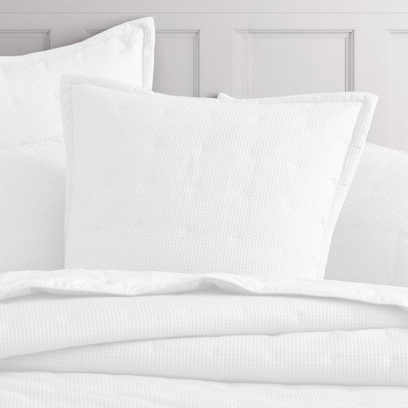 Elegant white European pillow sham with textured waffle weave, quilted design, and flanged edges, measuring 65cm x 65cm.