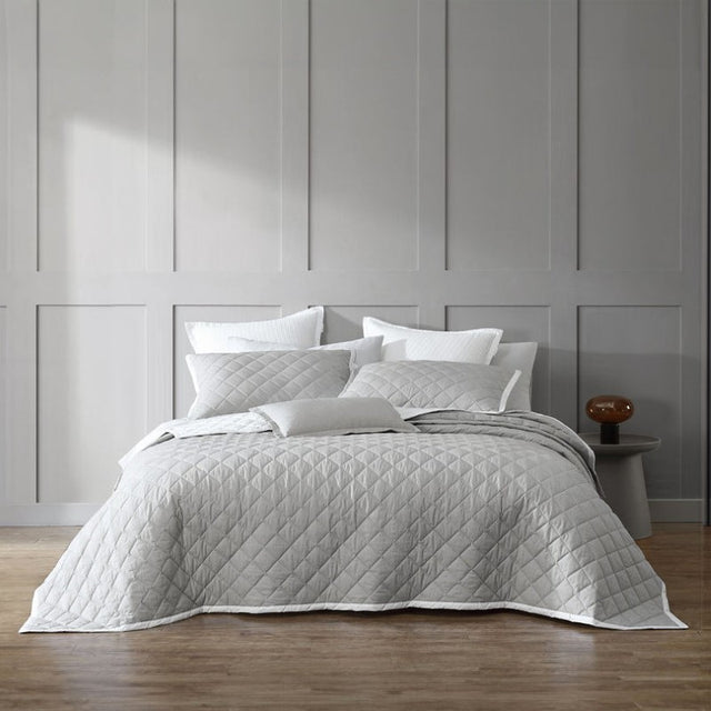 Elegant Logan & Mason Essex pewter bedspread featuring a quilted herringbone design and crisp white bound edge.